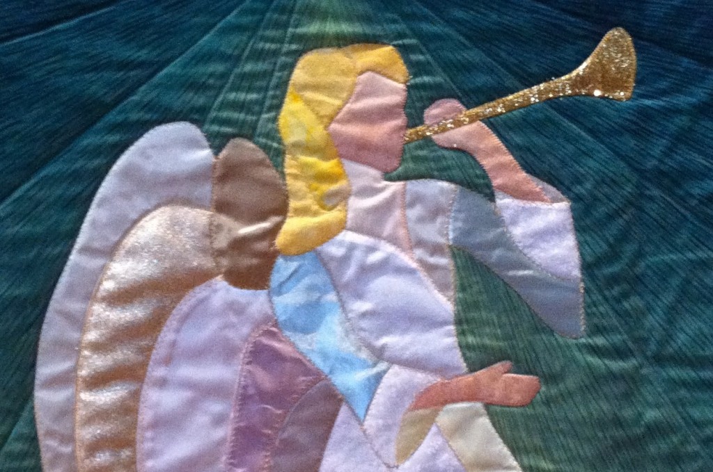 photo of quilted banner of angel with trumpet