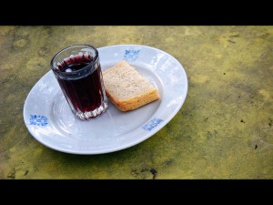 photo of slice of bread & cup of grape juice